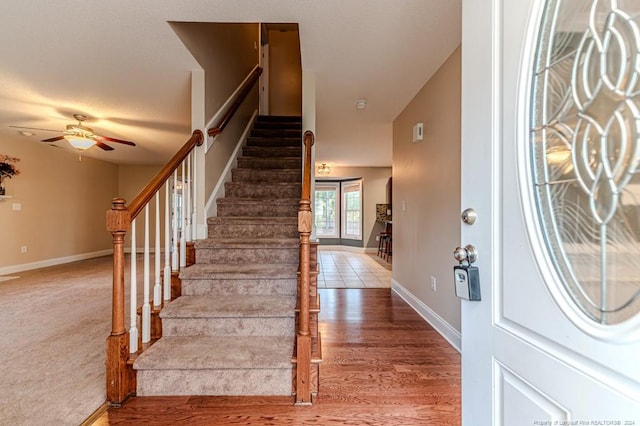 foyer with ceiling fan, hardwood / wood-style flooring, and lofted ceiling