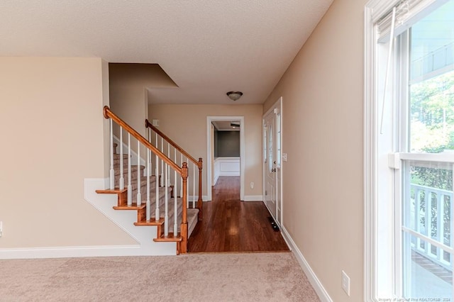 interior space featuring carpet floors and a textured ceiling