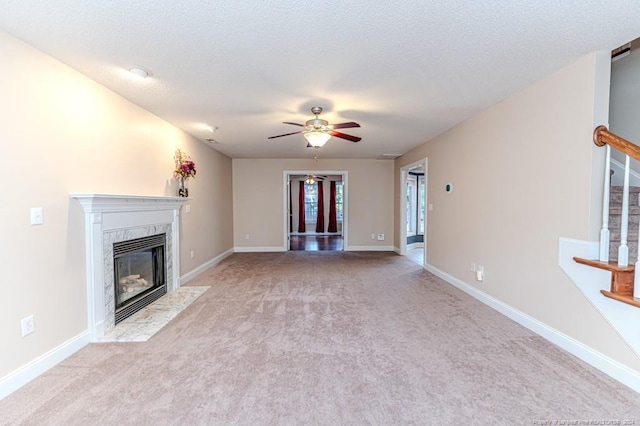 3375 Carolina Way, Sanford, NC 27332 - unfurnished living room featuring carpet floors, ceiling fan, a high end fireplace, stairway, and baseboards