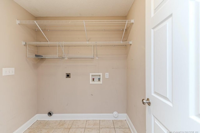 clothes washing area featuring light tile patterned flooring, washer hookup, and hookup for an electric dryer