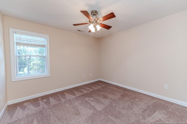 carpeted empty room with ceiling fan