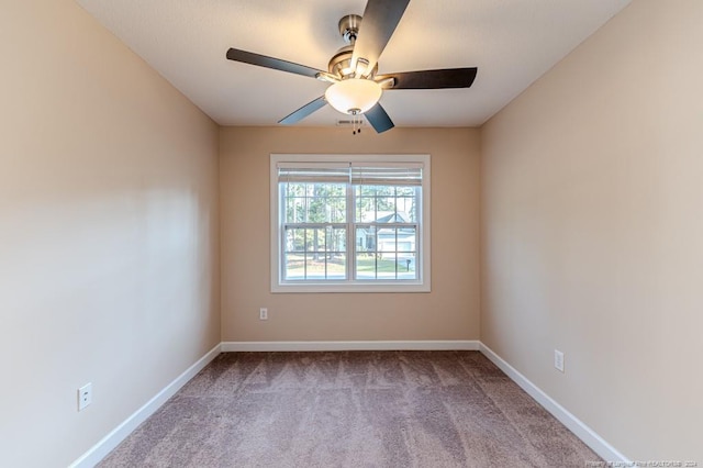 empty room with ceiling fan and carpet flooring