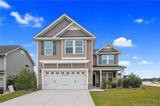 craftsman inspired home featuring a garage and a front lawn