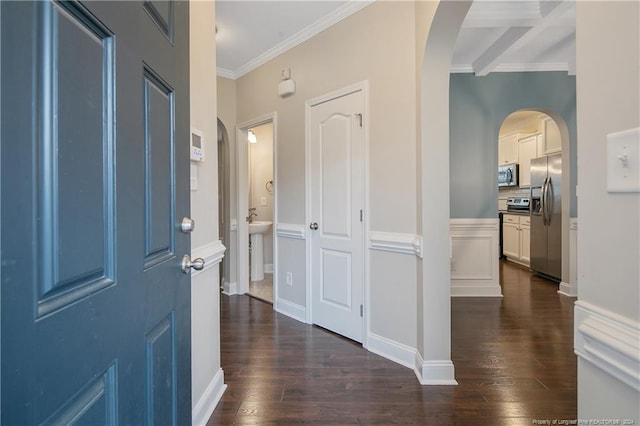 entrance foyer with crown molding, beam ceiling, and dark hardwood / wood-style flooring