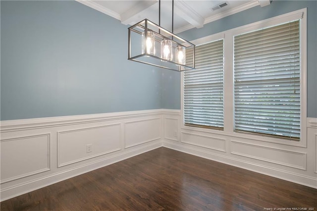 spare room featuring dark wood-type flooring, ornamental molding, and beam ceiling