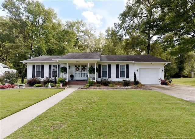 ranch-style home featuring a porch, a front yard, and a garage