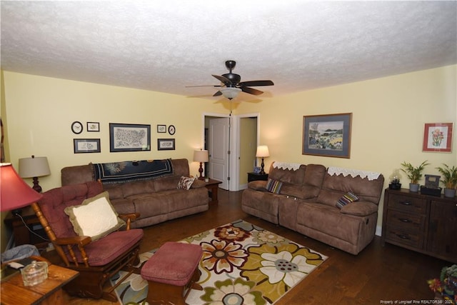 living room featuring a textured ceiling, ceiling fan, and dark hardwood / wood-style flooring