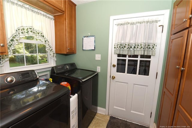3760 Berkley Ln, Lumberton, NC 28358 - laundry area featuring cabinet space, washing machine and clothes dryer, and light tile patterned floors