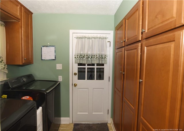 3760 Berkley Ln, Lumberton, NC 28358 - washroom with cabinet space, washer and clothes dryer, light tile patterned floors, and a textured ceiling