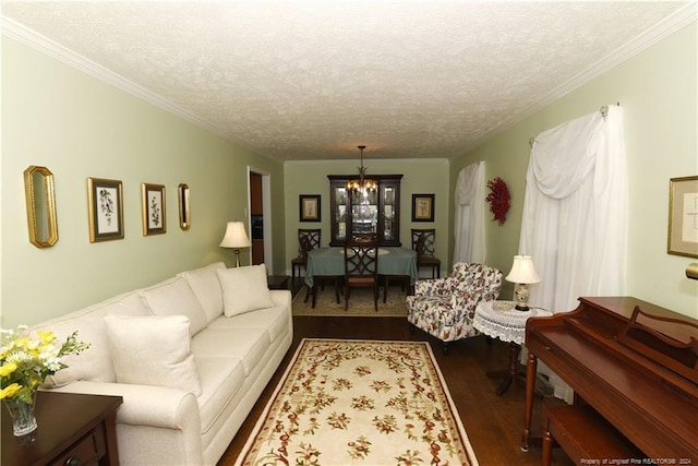 living room with a notable chandelier, crown molding, dark wood-type flooring, and a textured ceiling