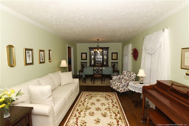 3760 Berkley Ln, Lumberton, NC 28358 - living room featuring dark wood-type flooring, ornamental molding, a textured ceiling, and a chandelier
