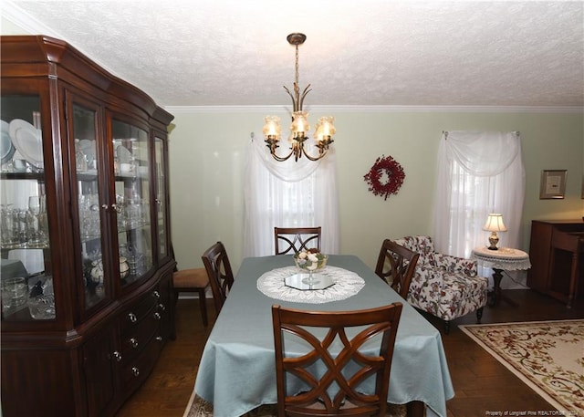 dining area featuring a textured ceiling, a notable chandelier, ornamental molding, and dark hardwood / wood-style flooring