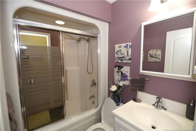 full bathroom with vanity, toilet, and combined bath / shower with glass door