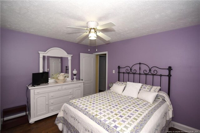 3760 Berkley Ln, Lumberton, NC 28358 - bedroom with dark wood-style floors, a ceiling fan, and a textured ceiling