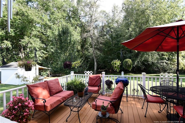 wooden deck featuring an outdoor living space, a yard, and a shed