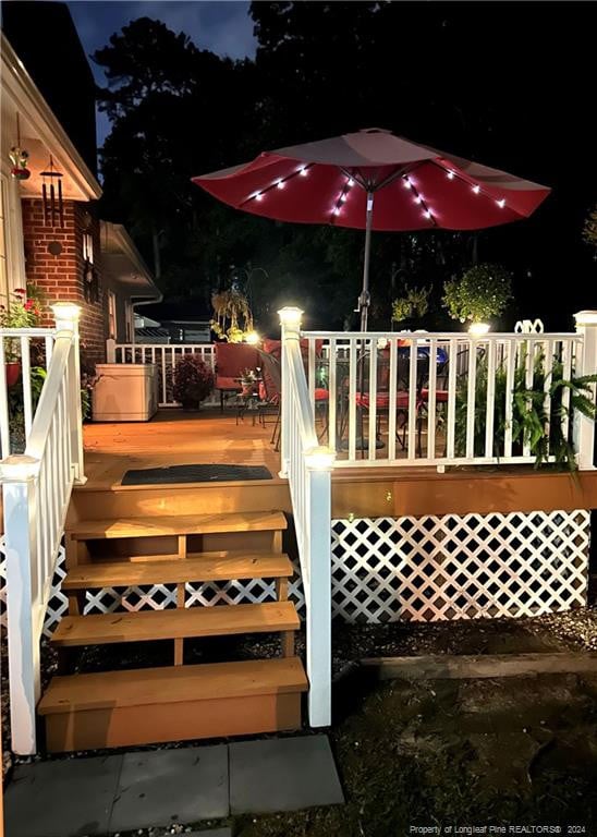 3760 Berkley Ln, Lumberton, NC 28358 - deck at night featuring stairway