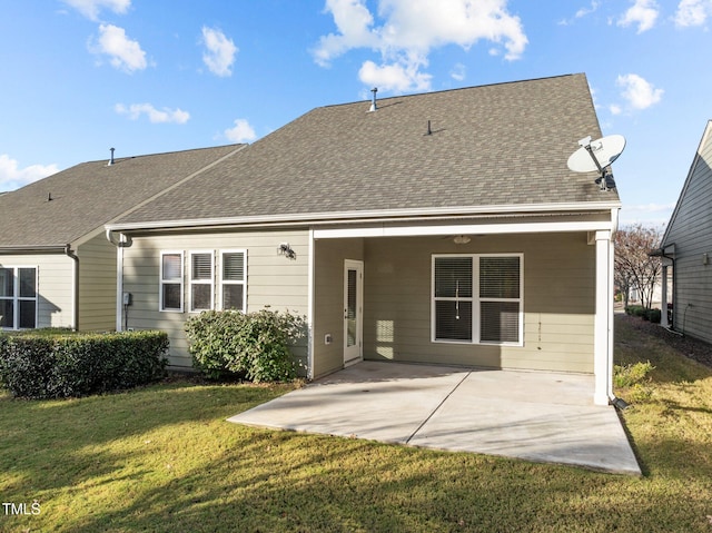 back of house with a patio and a lawn