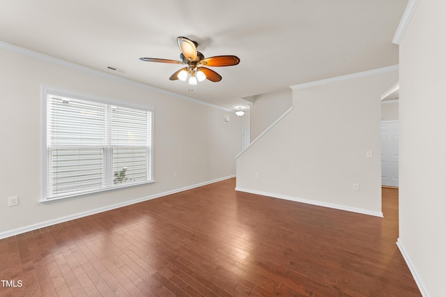 unfurnished room with ceiling fan, ornamental molding, and dark wood-type flooring