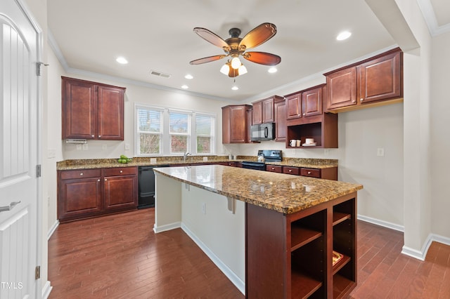 kitchen with light stone counters, a kitchen island, dark hardwood / wood-style floors, black appliances, and ornamental molding