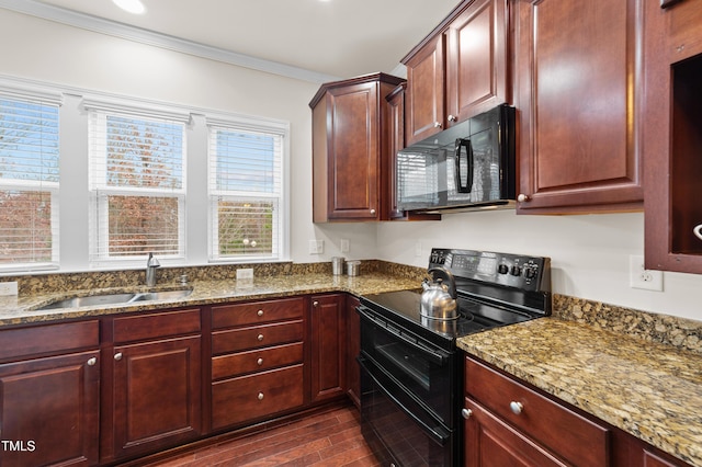 kitchen with dark stone countertops, sink, dark hardwood / wood-style floors, crown molding, and black appliances