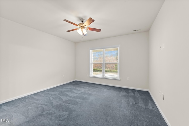 carpeted spare room featuring ceiling fan