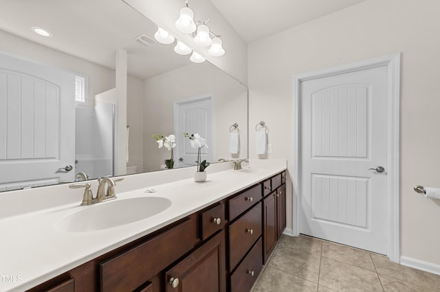 bathroom featuring tile patterned flooring, vanity, and toilet