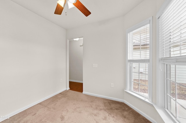 unfurnished room featuring ceiling fan and light carpet