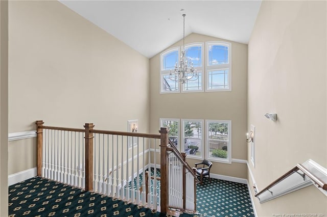 staircase with lofted ceiling, plenty of natural light, and carpet flooring