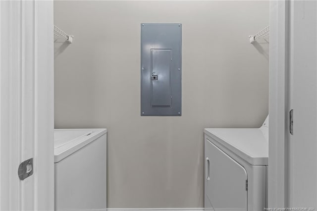 washroom featuring electric panel and separate washer and dryer