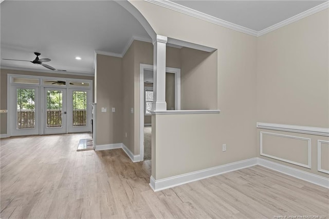 interior space featuring light hardwood / wood-style floors, crown molding, decorative columns, and ceiling fan