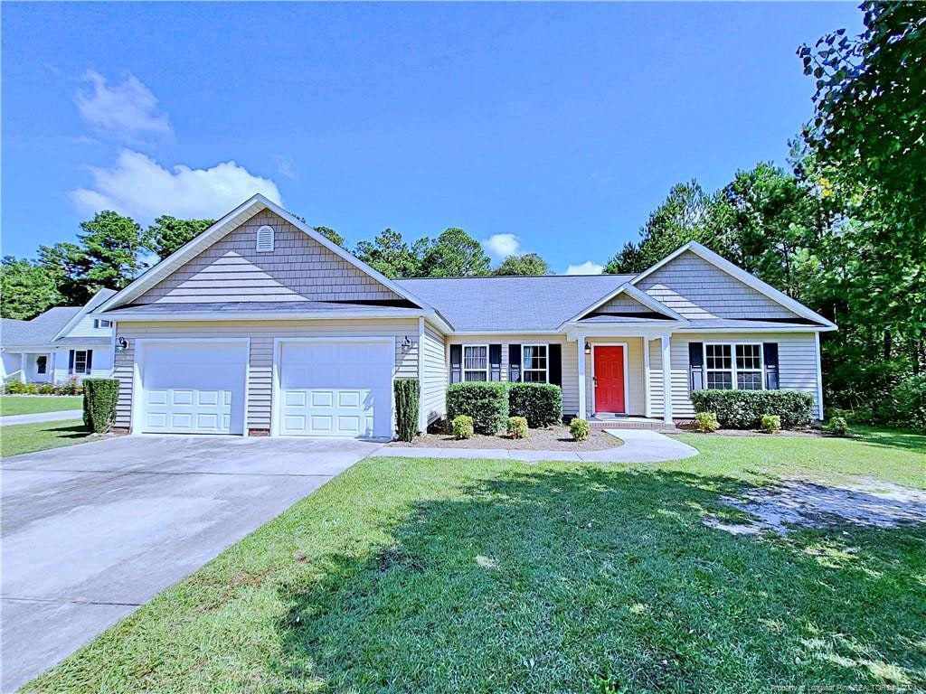 single story home with a front yard and a garage