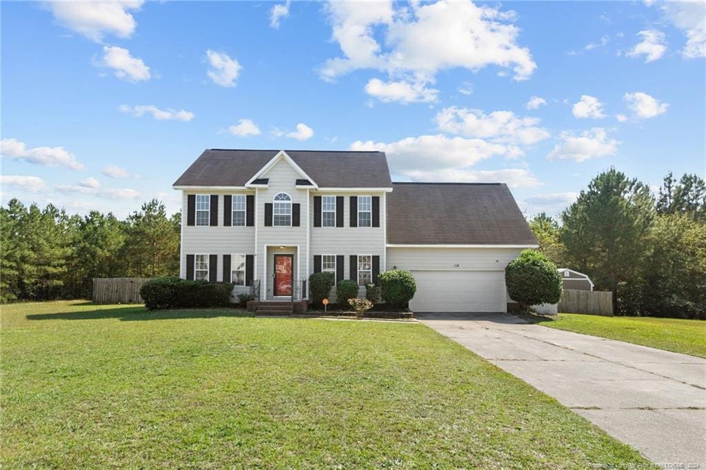 colonial-style house with a front lawn and a garage