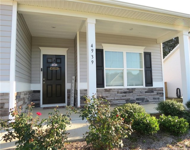 view of exterior entry featuring a porch