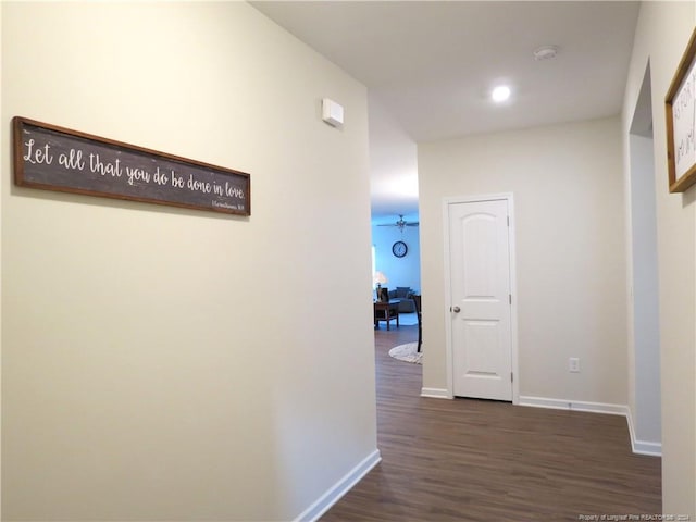 corridor with dark hardwood / wood-style flooring