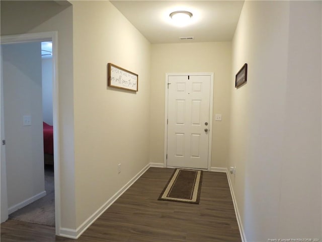 doorway with dark wood-type flooring