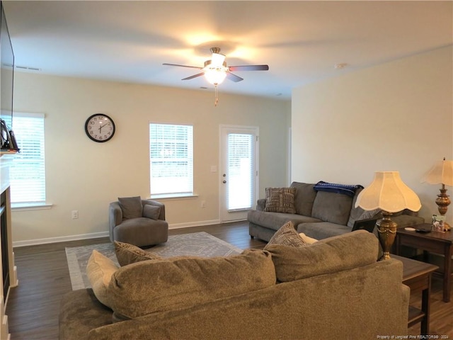 living room with dark hardwood / wood-style flooring and ceiling fan