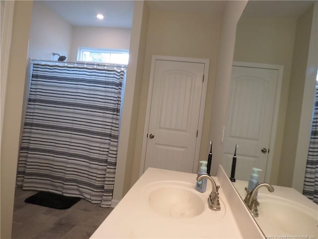 bathroom with walk in shower, vanity, and wood-type flooring