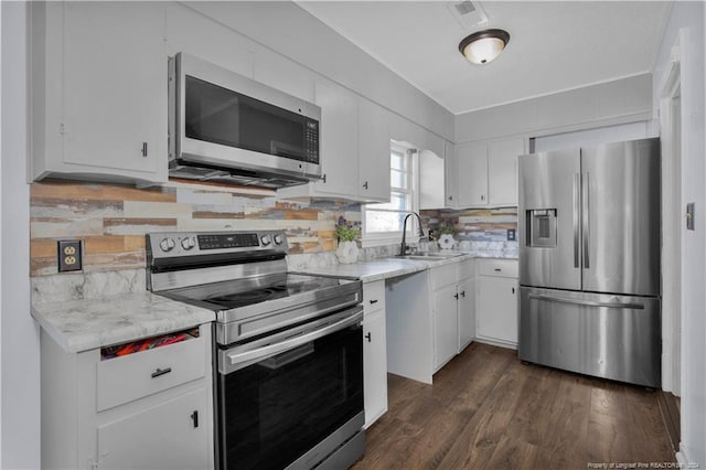 kitchen featuring stainless steel appliances, sink, and white cabinetry