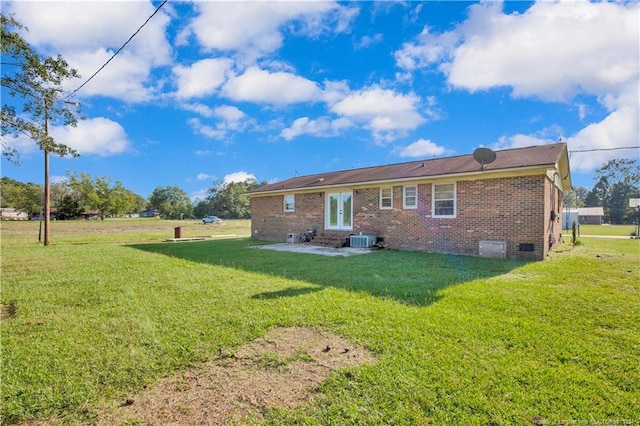 rear view of property with a lawn and central AC unit