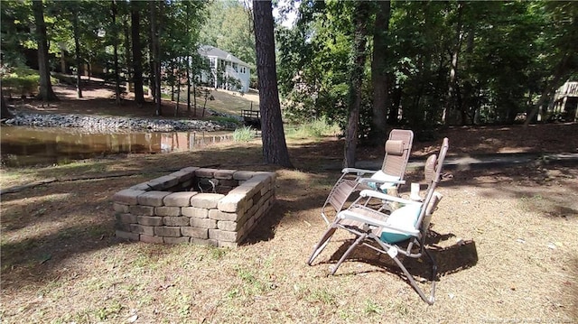 view of yard featuring an outdoor fire pit