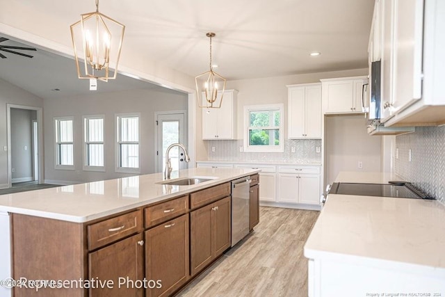 kitchen featuring white cabinetry, decorative light fixtures, and a kitchen island with sink