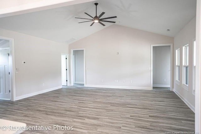 unfurnished living room with lofted ceiling, ceiling fan, and wood-type flooring