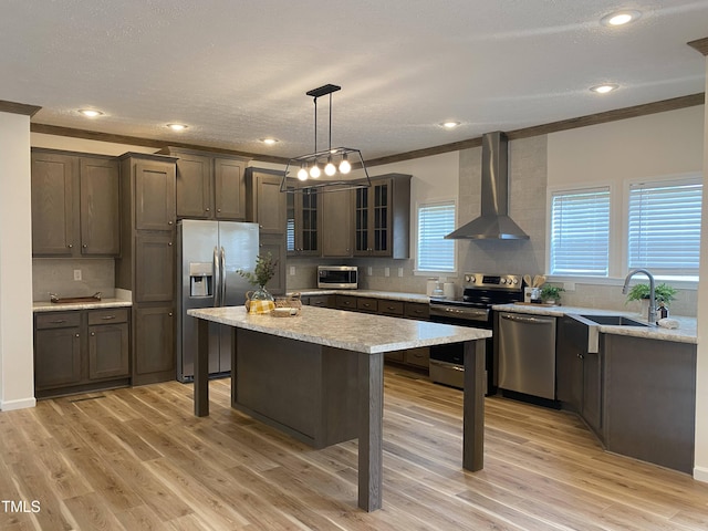 6733 Oscar Barham Rd, Wake Forest, NC 27587 - kitchen with appliances with stainless steel finishes, wall chimney exhaust hood, a sink, a kitchen bar, and tasteful backsplash