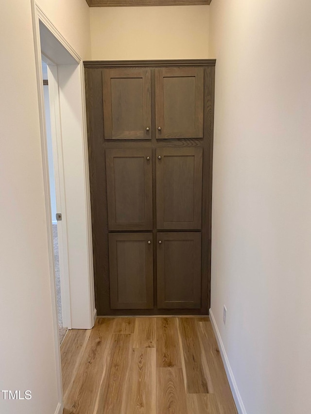 hallway with light hardwood / wood-style flooring