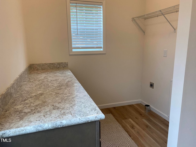 laundry room featuring hookup for an electric dryer and wood-type flooring