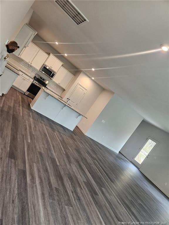 interior space featuring dark wood-type flooring and visible vents