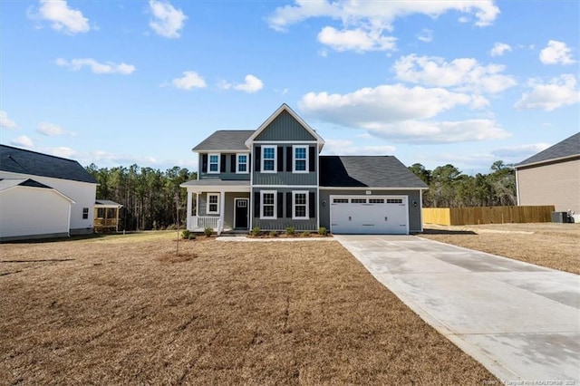 view of front facade featuring an attached garage, driveway, fence, and a front yard