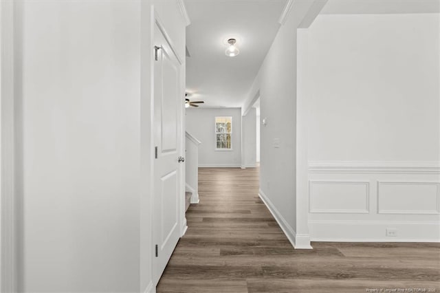 corridor with stairs, dark wood finished floors, and baseboards