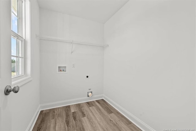 clothes washing area featuring laundry area, baseboards, wood finished floors, washer hookup, and electric dryer hookup