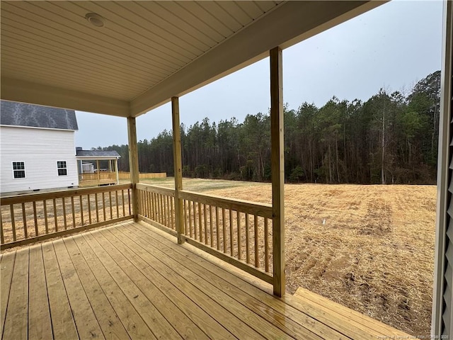 wooden deck featuring a view of trees